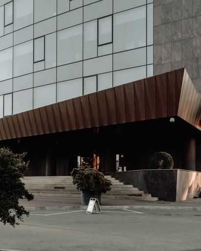A vertical shot of stairs leading to the entrance of a big hotel