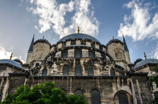 A low angle shot of the New Mosque against a cloudy sky in Istanbul, Turkey,