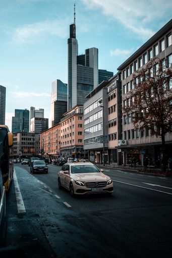 A vertical shot of modern car on the street with a Commerzbank Tower in Frankfurt, Germany