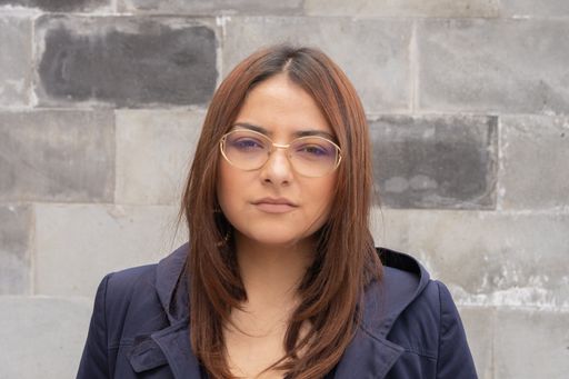 A portrait of a young Hispanic female at her workplace