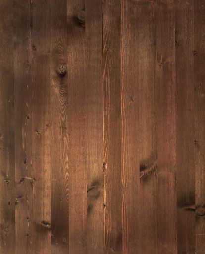 A vertical shot of a polished dark brown wood plank with copy space