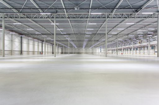 The interior of a new empty lighted warehouse ready to be used