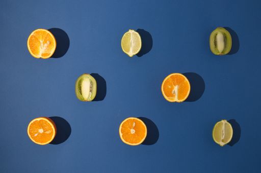 A top view of sliced fruits on a dark blue background