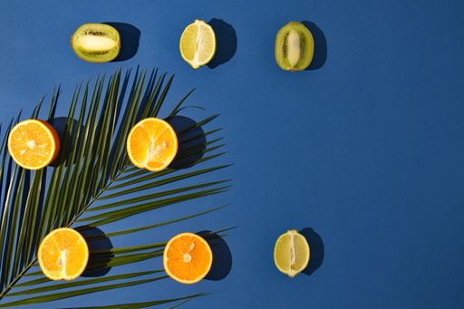 A top view of sliced fruits on a dark blue background