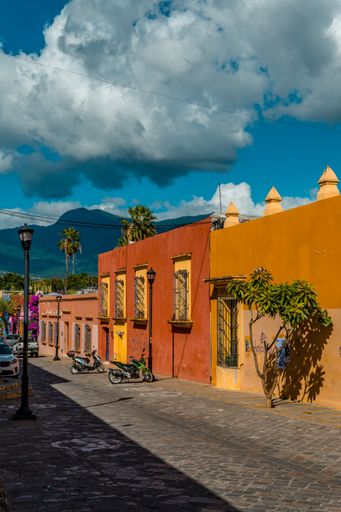 A closeup of beautiful street photography of colorful colonial houses in the center of Oaxaca Mexico