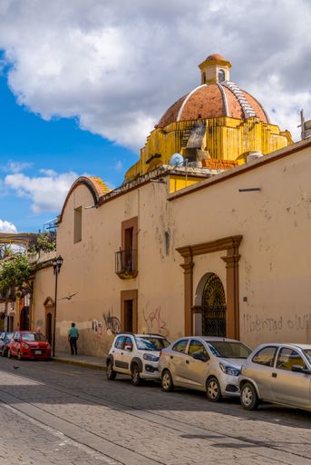 A vertical closeup shot of the colonial houses and church dome in the center of Oaxaca Mexico