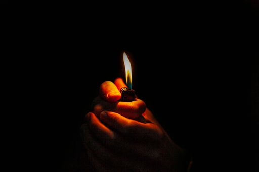 A closeup shot of a lighter in a person's hands