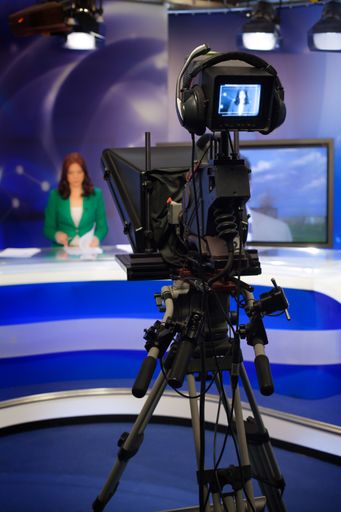 A video camera lens - recording a show in a TV studio