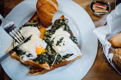 A high angle shot of an egg sandwich on a plate in a restaurant