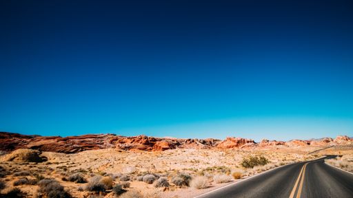 A driving trail through a sunny desert in Las Vegas, USA