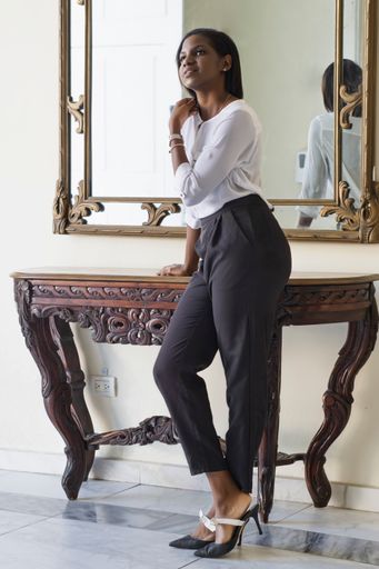 A vertical shot of an African American female leaning o