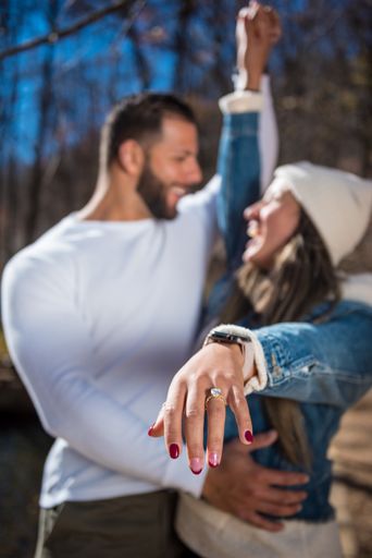 A closeup of a young happy couple excited to be engaged during wintertime