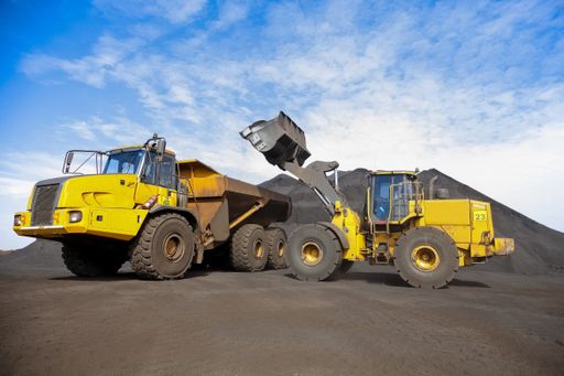 A Mining Dump Truck and wheel loader for transporting Manganese for processing