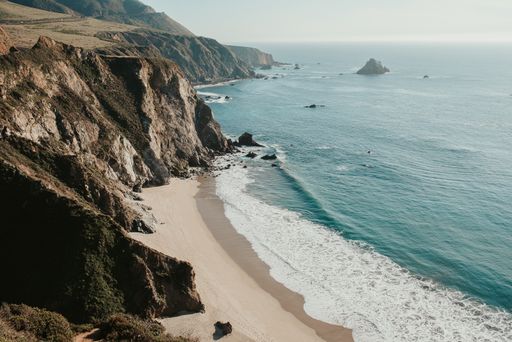 A high angle shot of a beautiful sea surrounded by rocky cliffs