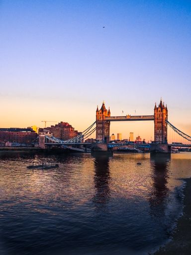 A vertical shot of a mesmerizing Tower Bridge above the River Thames at sunset