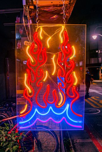 A vertical shot of a beautiful neon sign of a fire outdoors in Taiwan