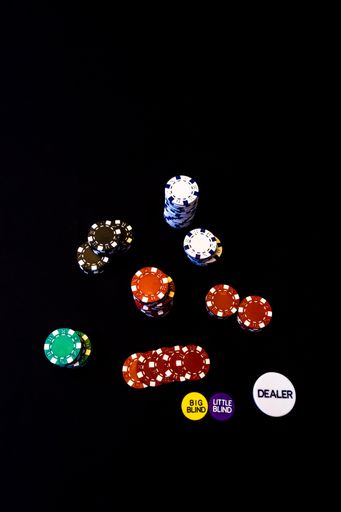 A top view of poker chip stacks in the black background