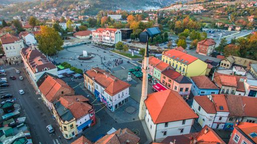 Aerial view of downtown Tuzla at sunset, Bosnia. City photographed by drone, traffic and objects , landscape. Old balkan buildings and communism type