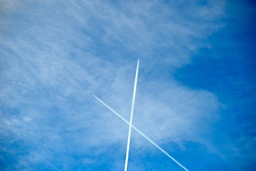 A low angle shot of a beautiful blue sky view with traces of planes
