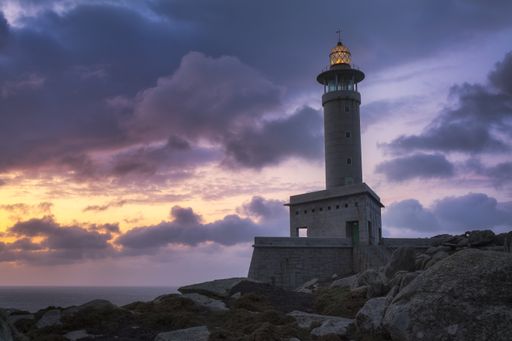 The Punta Nariga lighthouse in Galicia, Spain at sunset
