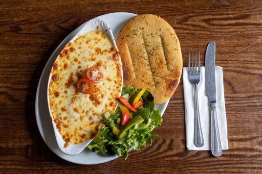 A top view of Cannelloni with Garlic Flatbread and salad