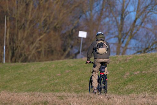 A closeup of a man riding a bicycle in the park