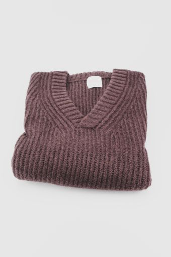 isolated dark brown knitted cloth on a white tabletop with text space
