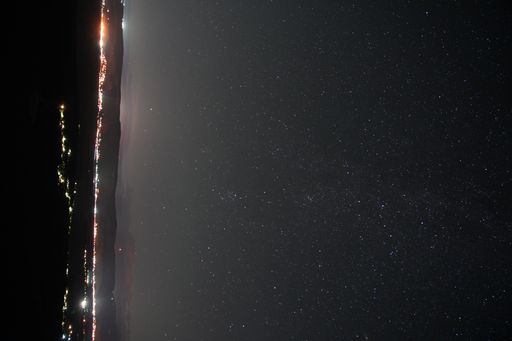 A beautiful shot of the starry sky above a town in the evening