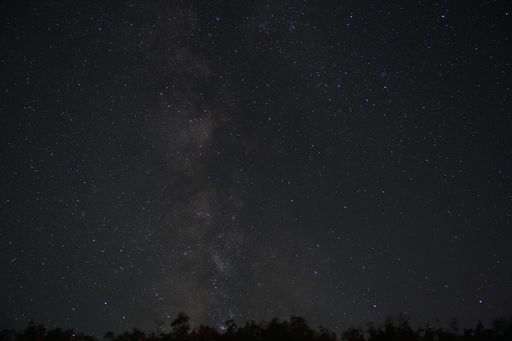 A beautiful shot of the starry sky above a town in the evening