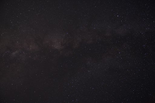 A beautiful shot of the starry sky above a town in the evening