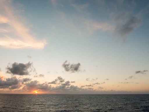 A beautiful landscape of sunrise or sunset over the sea against blue sky with dramatic clouds