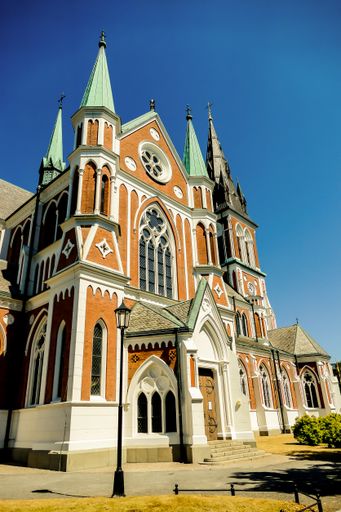 A vertical shot of a catholic church under a blue clear sky in Nordkapp, Norway