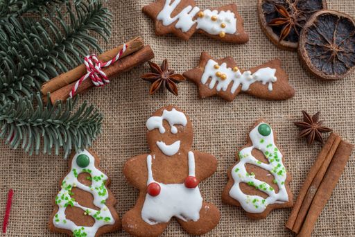 A top view of homemade gingerbread cookies decorated with cinammon and pine branches