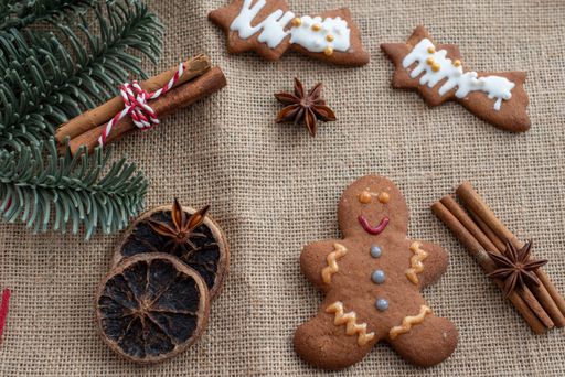 A top view of homemade gingerbread cookies decorated with cinammon and pine branches