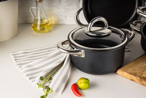 An angle shot of a cooking pot on a white surface.