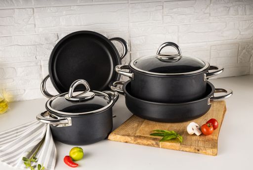 An angle shot of a cooking pot on a white surface.