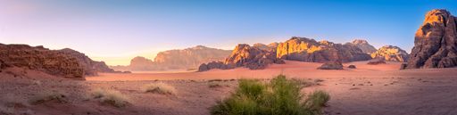 Panorama landscape shot of Wadi Rum desert in Jordan during golden hour. Travel and tourism.