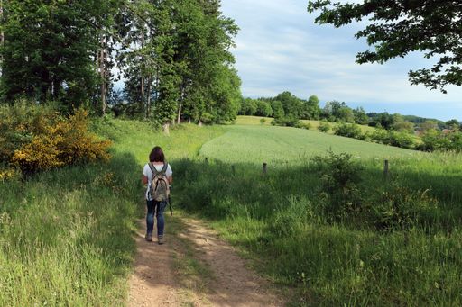 Woman walking on a rural dirt road in Central France