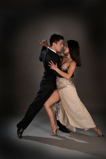A Latin female and an Asian male dancing tango