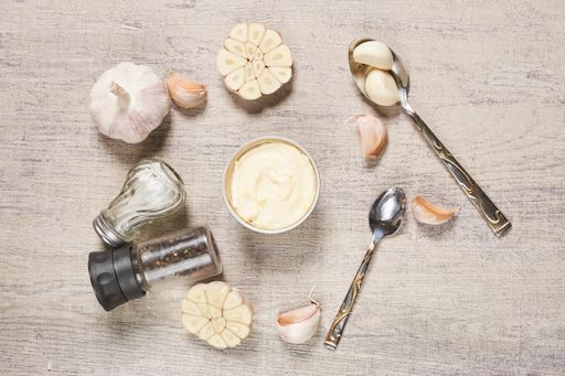 The process of cleaning organic garlic on a cutting board in a kitchen