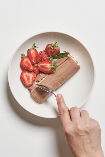 A top view shot of strawberries and chocolate ice cream in a bowl