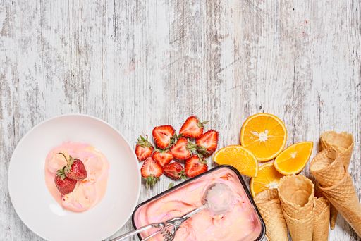 The refreshing strawberry ice cream with ripe strawberries, orange slices and waffle cones