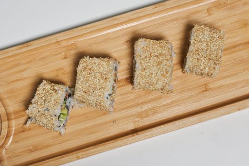 A top view shot of sushi rolls on a wooden surface