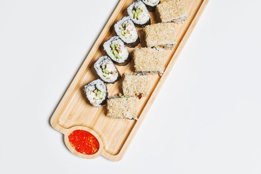 A top view of rolled sushi on a wooden stand isolated on white background