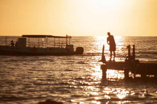 Fisherman on the pier at sunset in Bayahibe in the Dominican Republic