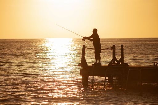 Fisherman on the pier at sunset in Bayahibe in the Dominican Republic