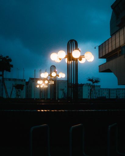A vertical shot of the street lamps in the evening.