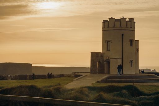 A beautiful view of a small tower building on the hill