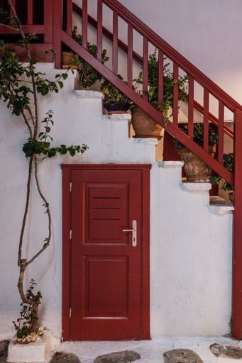 A vertical shot of a white building facade with red details