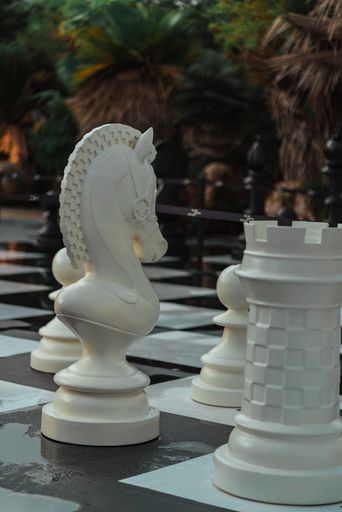 An outdoor chess board with big chess pieces
